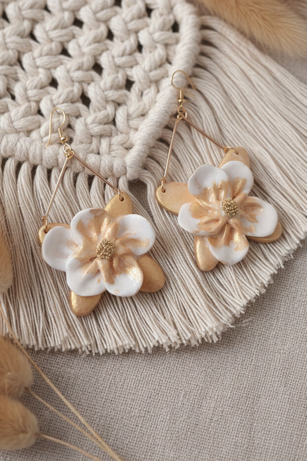 boucles d'oreilles artisanales qui capturent la magie des opales avec leurs reflets irisés dorés. Chaque paire est façonnée à la main en argile polymère, créant une pièce unique qui sublime votre style avec élégance et poésie.