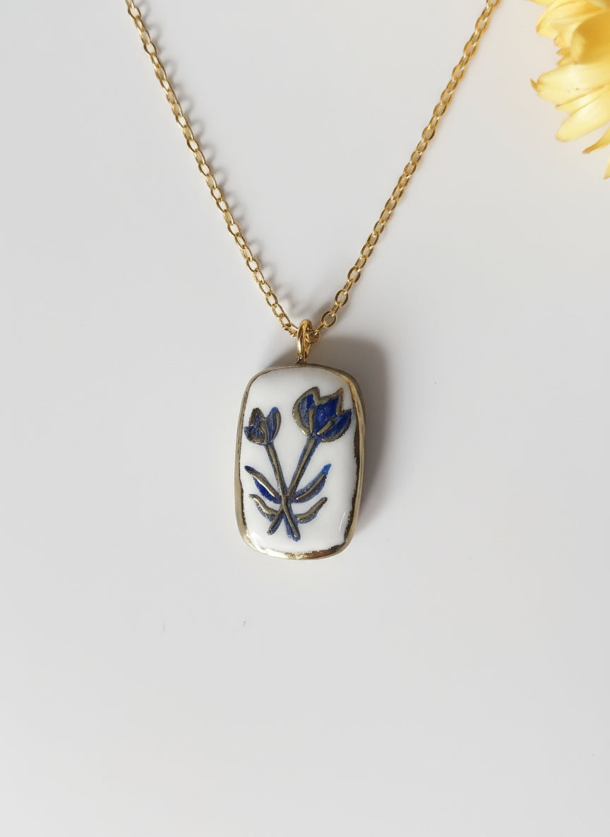 Pendentif bleu et doré fleur Talis&co -Argile polymère 